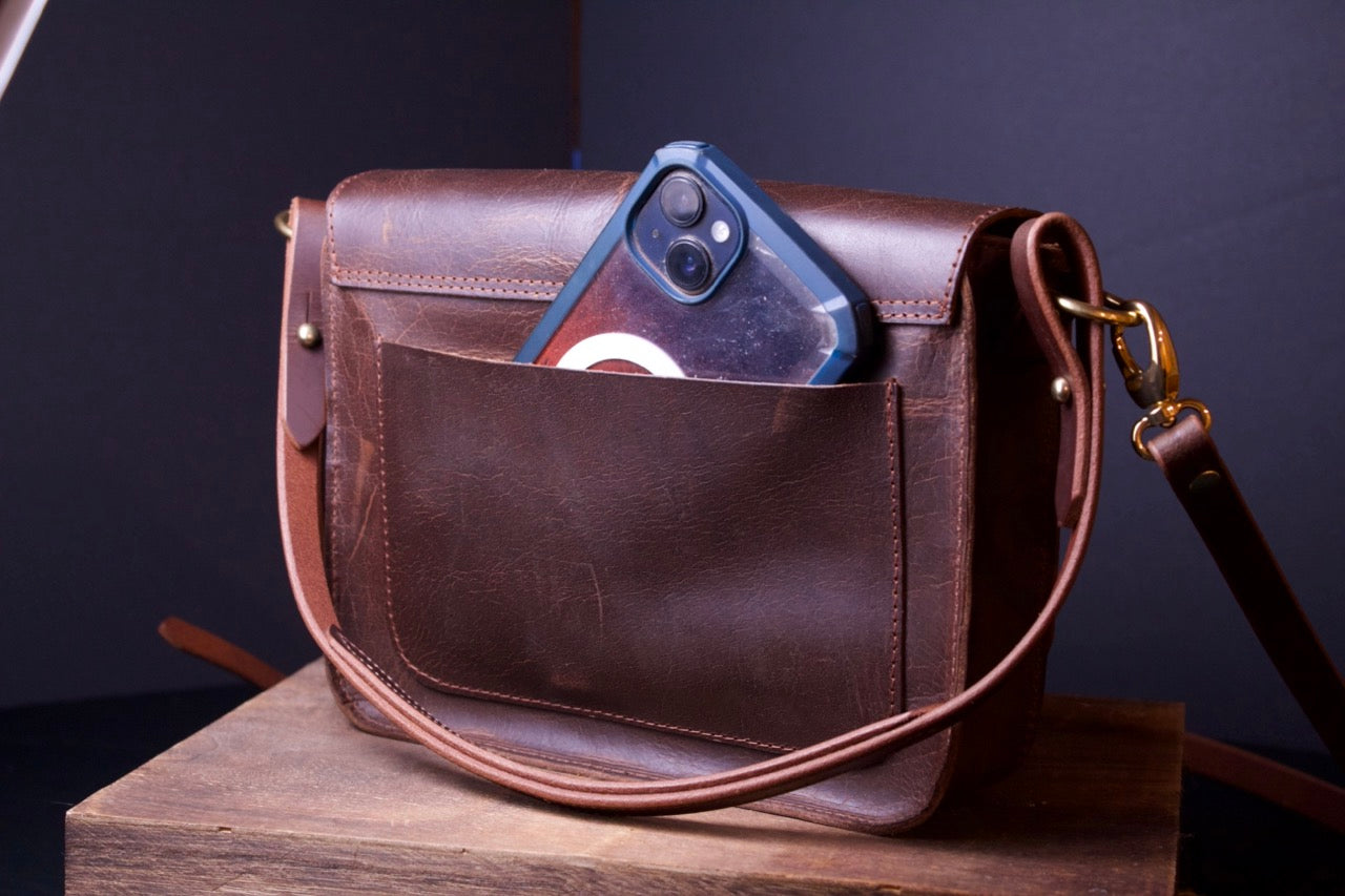 The Dixie Leather Handbag, brown women's purse, back view with phone