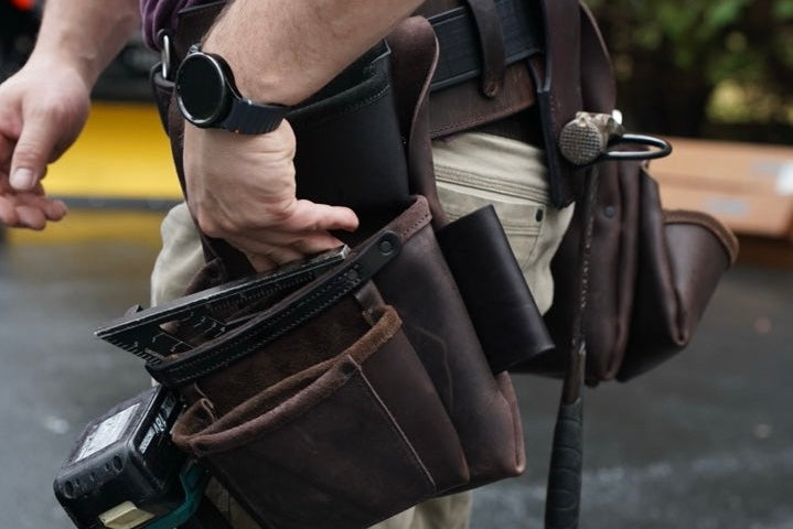 brown leather tool belt, side view on person